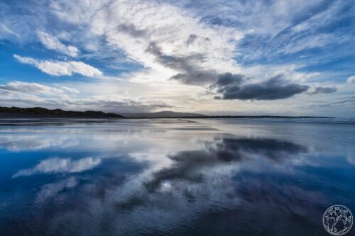 A stunning sky reflection on the wet sands of Strandhill Beach, County Sligo, at low tide on the Wild Atlantic Way.