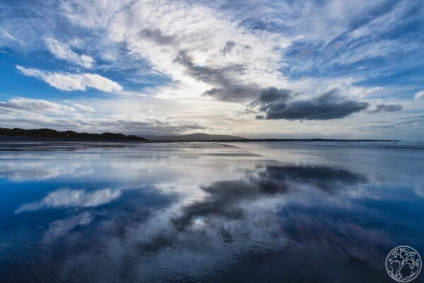 A stunning sky reflection on the wet sands of Strandhill Beach, County Sligo, at low tide on the Wild Atlantic Way.